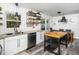 Bright kitchen features stainless steel appliances, granite countertops, white cabinetry, and an island for extra prep space at 416 Avery St, Garner, NC 27529