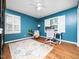 Inspiring home office featuring hardwood floors, blue walls, a ceiling fan and ample natural light at 416 Avery St, Garner, NC 27529