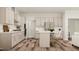 Elegant kitchen with white cabinetry, stainless steel appliances, and hardwood flooring at 417 Cresting Wave Dr, Wake Forest, NC 27587