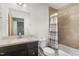 Bathroom with tile shower, vanity, decorative mirror, and neutral accents at 4229 American Dr # F, Durham, NC 27705
