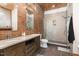 Bathroom featuring double vanity, tiled floors, and glass-enclosed shower at 4229 American Dr # F, Durham, NC 27705