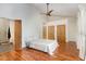 Bright bedroom with hardwood floors, ceiling fan, and attached bathroom at 4229 American Dr # F, Durham, NC 27705