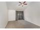 Bedroom with ceiling fan, neutral carpet, and a sliding glass door to a balcony at 4229 American Dr # F, Durham, NC 27705
