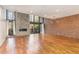 Open living space with fireplace, hardwood floors, and oversized windows at 4229 American Dr # F, Durham, NC 27705