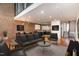 Open concept living room with exposed brick wall and modern furnishings at 4229 American Dr # F, Durham, NC 27705