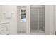 Modern bathroom featuring a glass enclosed shower, and a bright window at 425 Cresting Wave Dr, Wake Forest, NC 27587