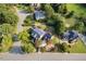 Aerial view of home with solar panels surrounded by lush trees in a charming neighborhood at 4303 Thetford Rd, Durham, NC 27707