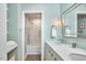 Bright bathroom features a double vanity, tub-shower combo, and built-in shelving for extra storage at 4303 Thetford Rd, Durham, NC 27707