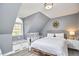 Serene bedroom features a dormer window with window seat, complemented by a gold bed frame at 4303 Thetford Rd, Durham, NC 27707