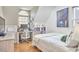 Cozy bedroom featuring a work/study area with a large window, complemented by hardwood floors at 4303 Thetford Rd, Durham, NC 27707