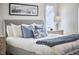 Well-lit bedroom with calming colors, decorative pillows, and a cozy throw blanket creating a serene retreat at 4303 Thetford Rd, Durham, NC 27707