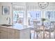 Bright breakfast nook features backyard views, a round table, and seating beside a modern kitchen at 4303 Thetford Rd, Durham, NC 27707