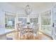 Inviting breakfast nook features a round table, chairs, large windows, and backyard views at 4303 Thetford Rd, Durham, NC 27707