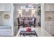 Light-filled dining room showcasing elegant lighting and a view into other living spaces at 4303 Thetford Rd, Durham, NC 27707
