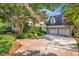 Charming home featuring a front porch, blooming tree and a two car garage with basketball hoop at 4303 Thetford Rd, Durham, NC 27707