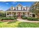 Charming home with a welcoming front porch, manicured landscaping, and a bright red front door at 4303 Thetford Rd, Durham, NC 27707