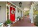Cozy front porch showcases a bright red door, outdoor seating, and traditional style at 4303 Thetford Rd, Durham, NC 27707
