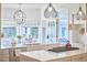 Modern kitchen offers a center island, stainless appliances, and a breakfast nook with backyard views at 4303 Thetford Rd, Durham, NC 27707