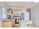 Bright kitchen with white appliances, wood cabinets, and a butcher block island on hardwood floors at 4303 Thetford Rd, Durham, NC 27707
