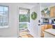 Bright and airy kitchen leading to the balcony with modern appliances and ample counter space at 4303 Thetford Rd, Durham, NC 27707