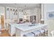 Bright kitchen featuring white cabinets, stainless steel appliances, an island, and seating at the counter at 4303 Thetford Rd, Durham, NC 27707