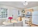Cozy kitchen with a dining area, wood cabinets, and natural light at 4303 Thetford Rd, Durham, NC 27707