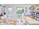 Bright and airy kitchen leading to the balcony with modern appliances and ample counter space at 4303 Thetford Rd, Durham, NC 27707