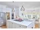 Bright kitchen features white cabinets, stainless steel appliances, an island, and breakfast nook at 4303 Thetford Rd, Durham, NC 27707