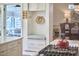 The kitchen has a sitting bench with a decorative hat hanging above the seating at 4303 Thetford Rd, Durham, NC 27707