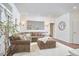 Spacious living room with hardwood floors, a brown sectional sofa, and stylish decor at 4303 Thetford Rd, Durham, NC 27707