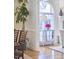 Open living area featuring hardwood floors, a mirrored console table, and large windows at 4303 Thetford Rd, Durham, NC 27707
