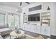 Living area with custom built-ins, a TV, and access to outdoor space at 4303 Thetford Rd, Durham, NC 27707
