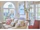 Bright living room with large windows, comfortable sofa, and stylish decorative accents at 4303 Thetford Rd, Durham, NC 27707