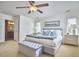 Bright main bedroom featuring a plush bed, side tables, and a window with natural light streaming in, plus en-suite bath at 4303 Thetford Rd, Durham, NC 27707