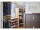 Custom walk-in closet with shelving for clothing and storage, featuring natural light and a neutral color palette at 4303 Thetford Rd, Durham, NC 27707