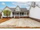 View of the back of the home showcasing the spacious patio and access to a screened-in porch at 44 Loop Rd, Archer Lodge, NC 27527