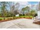 Backyard featuring a concrete patio and shed, set amidst a well-manicured lawn and landscaping at 44 Loop Rd, Archer Lodge, NC 27527