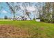 Expansive backyard with lush greenery, mature trees, and additional storage shed at 44 Loop Rd, Archer Lodge, NC 27527