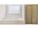 Bright bathroom with a tub, shower, and stylish neutral finishes at 44 Loop Rd, Archer Lodge, NC 27527