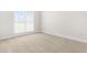Neutral-toned bedroom with carpet, base trim and large window with natural light at 44 Loop Rd, Archer Lodge, NC 27527