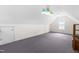 Versatile bonus room with neutral carpet, sloped ceilings, and ample natural light at 44 Loop Rd, Archer Lodge, NC 27527