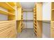 Large, custom-built walk-in closet with wooden shelving and drawers at 44 Loop Rd, Archer Lodge, NC 27527