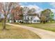 Charming home with a welcoming front porch, complemented by a well-manicured lawn and mature trees at 44 Loop Rd, Archer Lodge, NC 27527