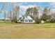 View of the house with a welcoming front porch and a large, open front yard at 44 Loop Rd, Archer Lodge, NC 27527