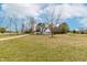 Well-maintained home with a lush front lawn and mature trees, offering curb appeal and space at 44 Loop Rd, Archer Lodge, NC 27527