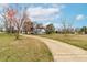 Charming home with a manicured lawn, long drive and mature trees, offering curb appeal at 44 Loop Rd, Archer Lodge, NC 27527