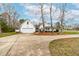 View of the house with a two-car garage and driveway, surrounded by mature trees at 44 Loop Rd, Archer Lodge, NC 27527