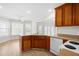 Open-concept kitchen boasts a breakfast nook, wood cabinets, and a view of the spacious backyard at 44 Loop Rd, Archer Lodge, NC 27527