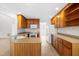 Bright kitchen features wood cabinets, updated appliances, and modern flooring for a delightful cooking experience at 44 Loop Rd, Archer Lodge, NC 27527