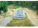 Stunning aerial view of a home with a metal roof nestled in a lush forest at 468 Loftis Loop Rd, Roxboro, NC 27574
